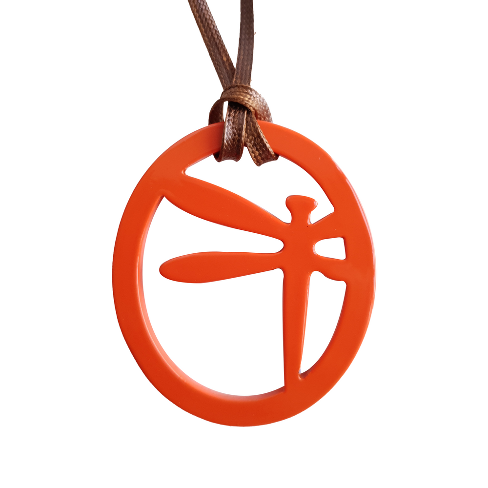 
                  
                    elliptical orange peel pendant with dragonfly pattern inside on the light background, impressive gift for her
                  
                