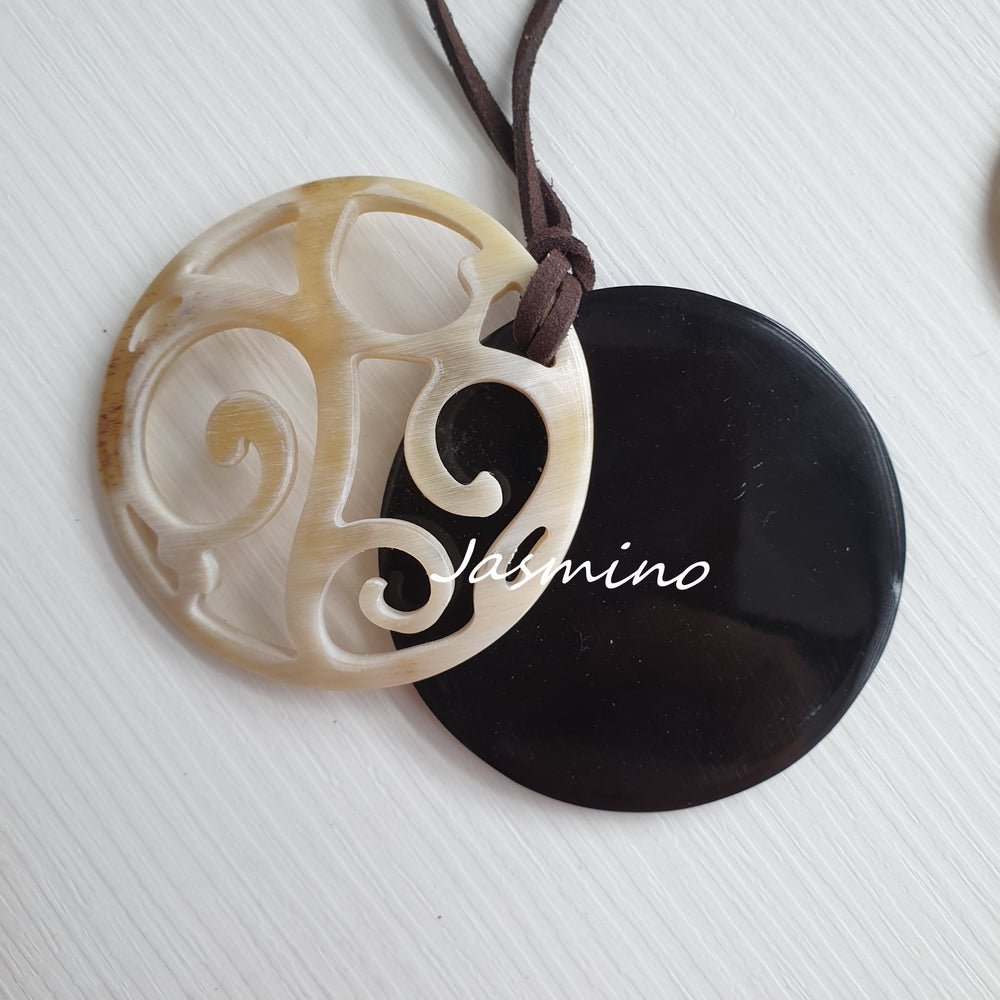 
                  
                    natural horn pendant on the light background, impressive gift for her
                  
                