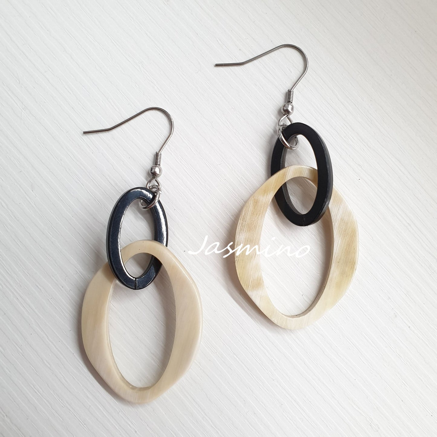 Jasmino luxury fancy double circle dangle earrings feature black and white in the natural light