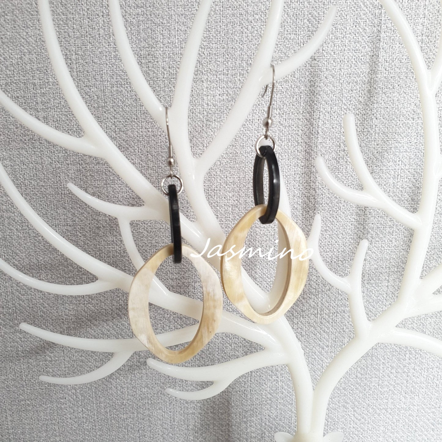 Jasmino luxury fancy double circle dangle earrings feature black and white in the natural light