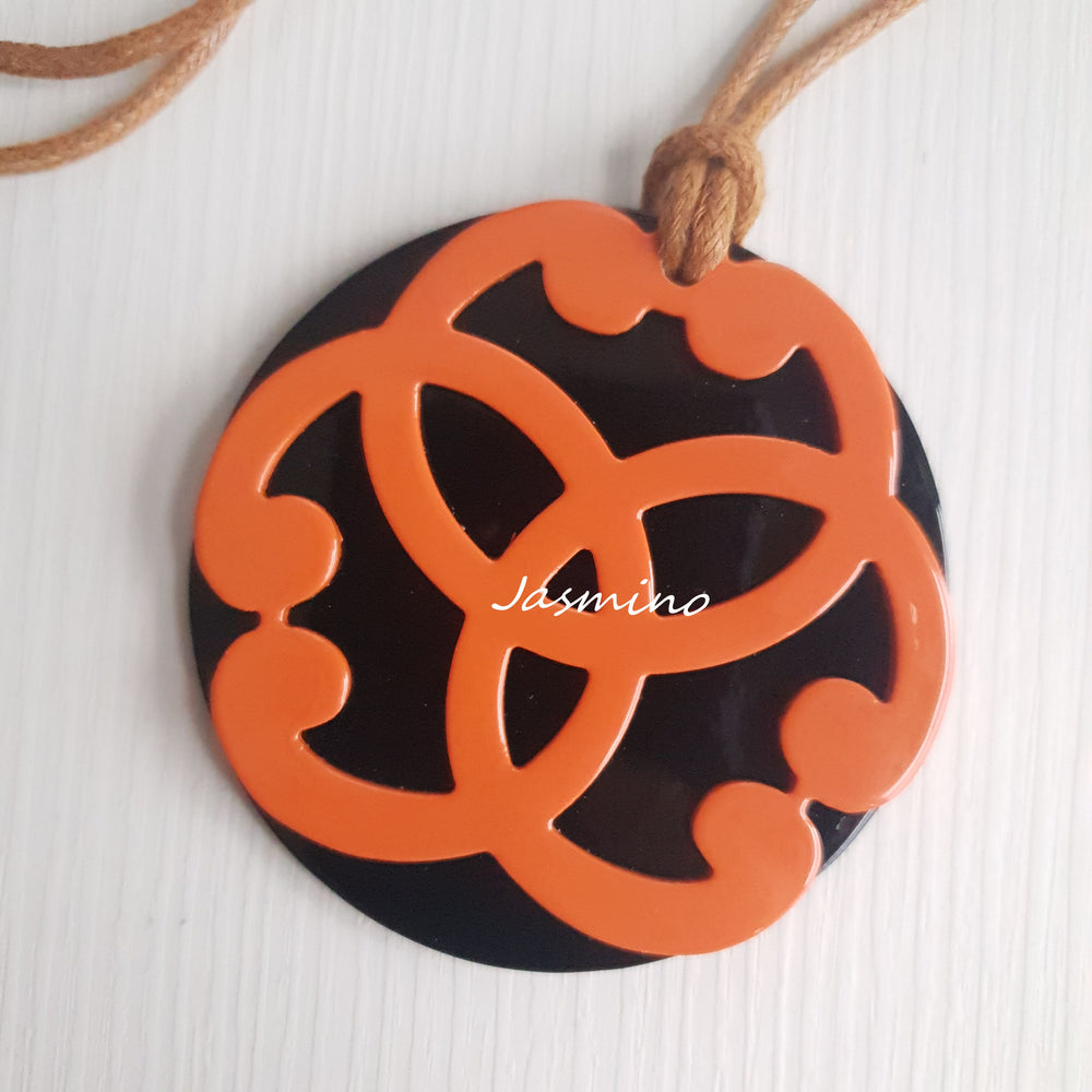 
                  
                    circle orange horn pendant on the light background, impressive gift for her
                  
                