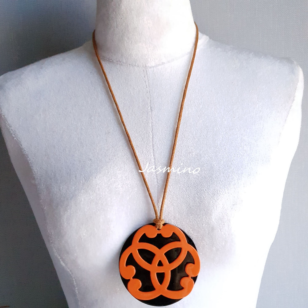 
                  
                    circle orange horn pendant on the light background, impressive gift for her
                  
                