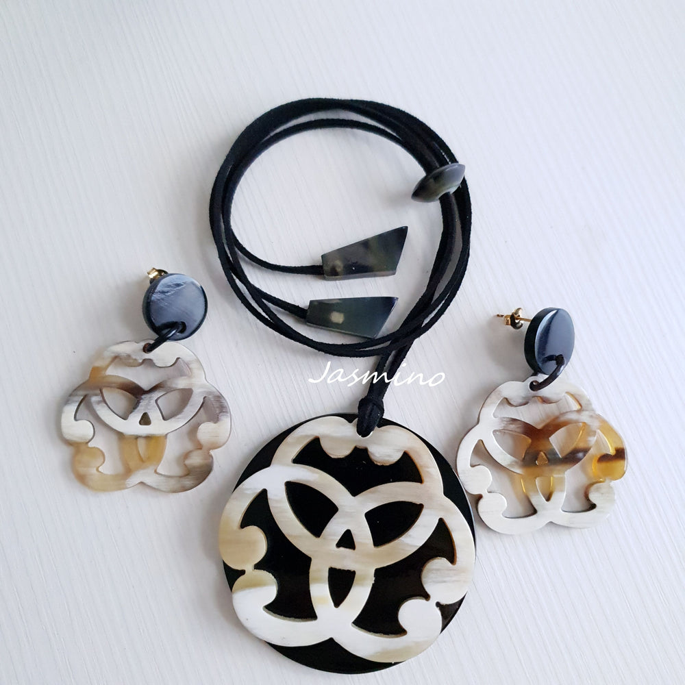 
                  
                    A set of unique handmade circle drop earrings and pendant is detailed by a flower shape in natural buffalo horn for women's gifts
                  
                