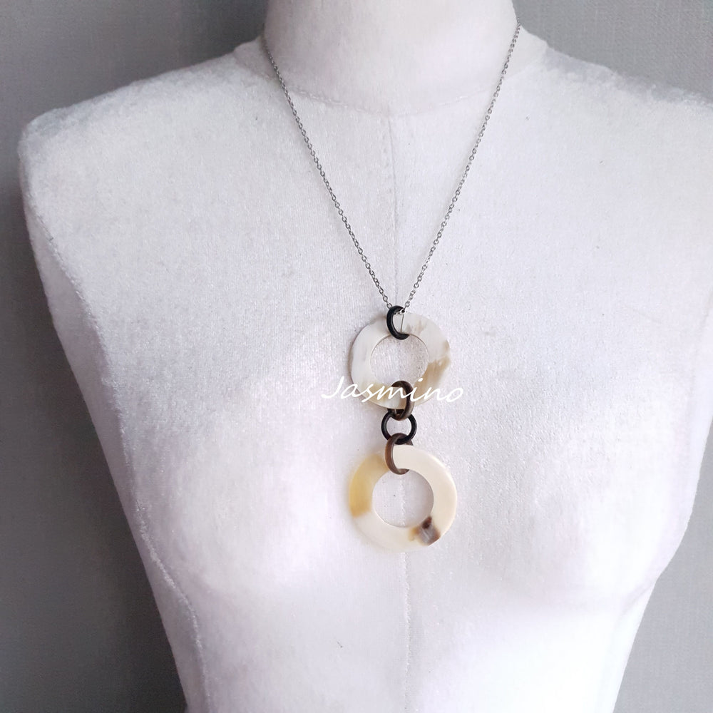 
                  
                    natural horn necklace on the light background, unique gift for your friend
                  
                