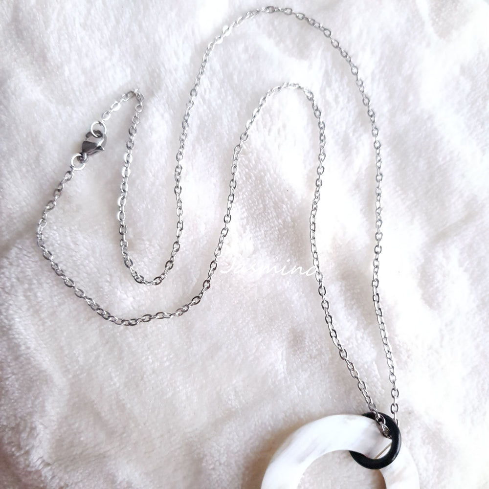 
                  
                    natural horn necklace on the light background, unique gift for your friend
                  
                