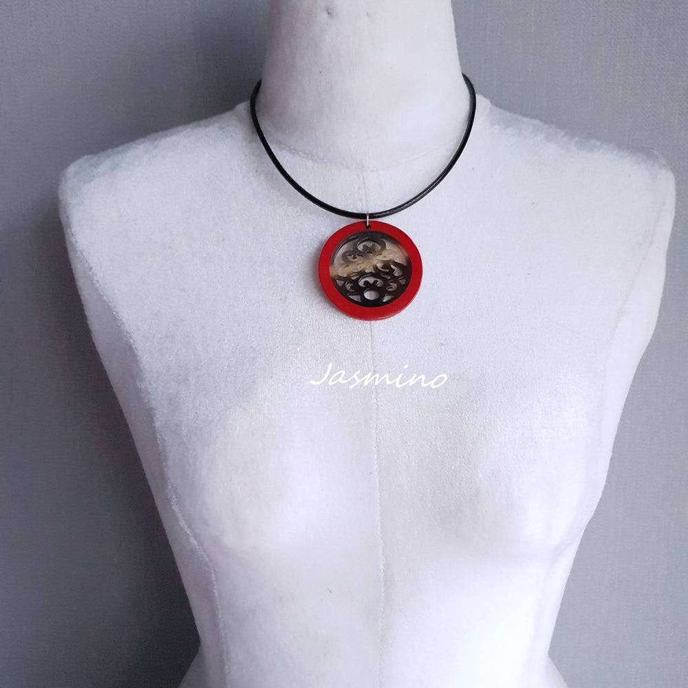 
                  
                    necklace has a circle pendant with scarlet outline, inside with unique pattern made from natural buffalo horn on the light background, impressive Christmas gift for her
                  
                