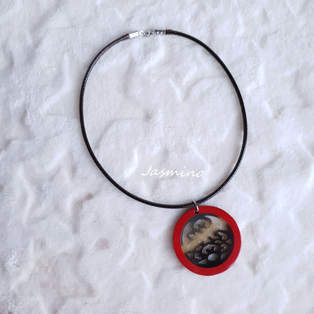 
                  
                    necklace has a circle pendant with scarlet outline, inside with unique pattern made from natural buffalo horn on the light background, impressive Christmas gift for her
                  
                