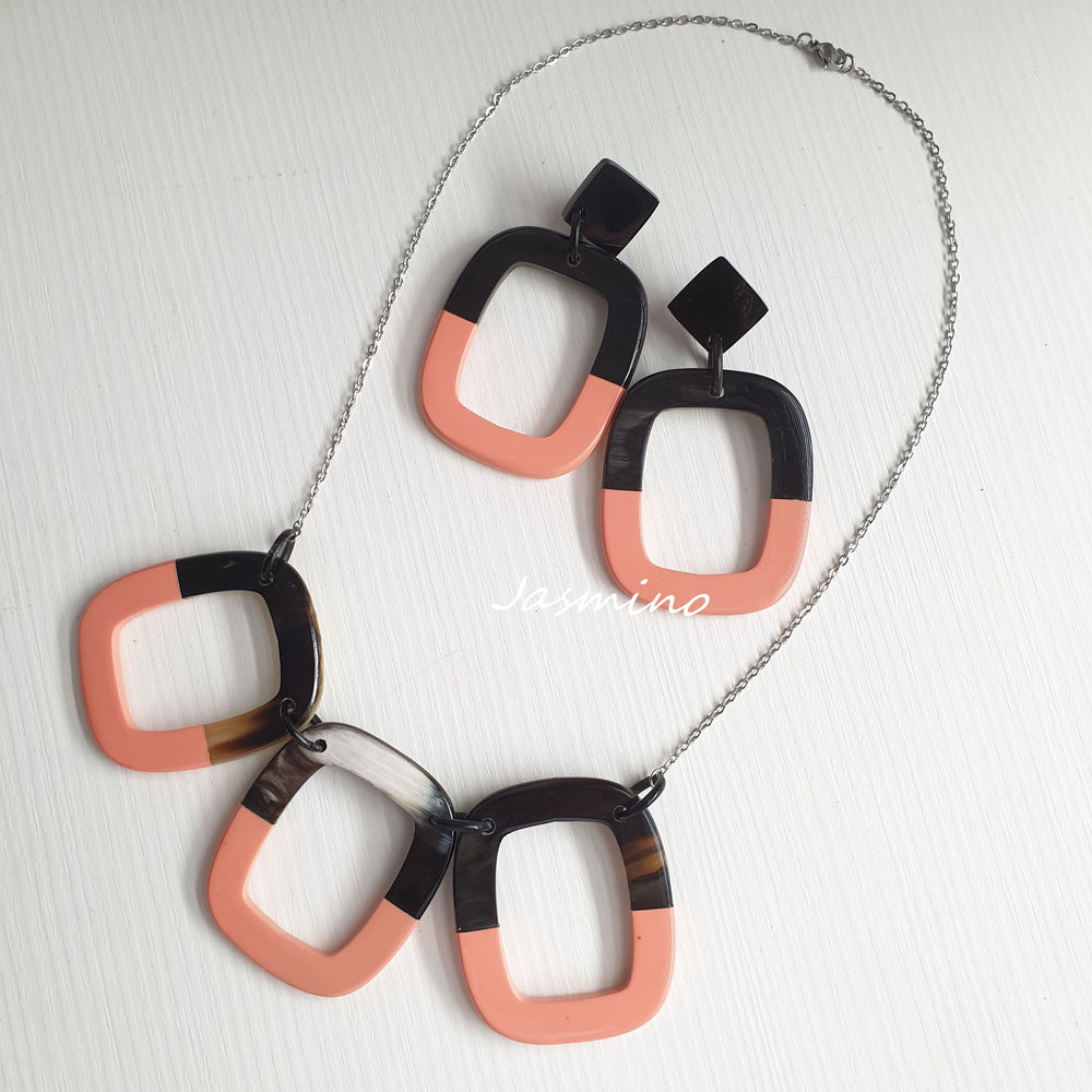 
                  
                    A set of unique handmade Bohemian earrings and necklace jewelry features black and pink in natural buffalo horn
                  
                