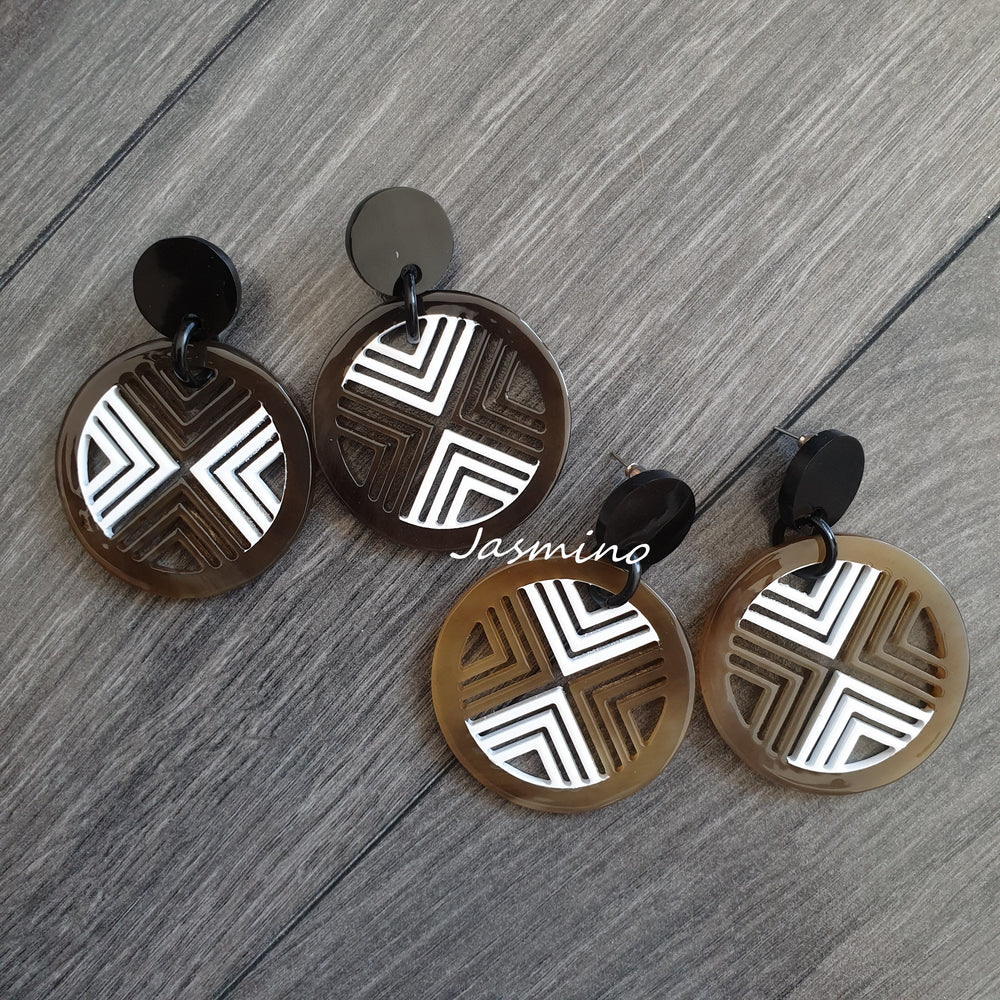 
                  
                    A set of two Ethnic Chic circle drop earrings feature brown and red color in the natural light
                  
                