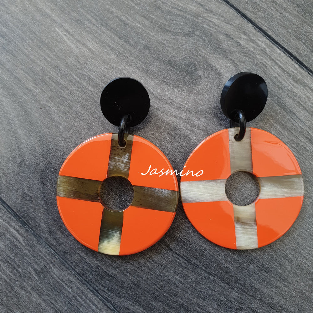 
                  
                    Jasmino Trendy Round Cross Drop Earrings Feature Orange and Brown Color In The Natural Light
                  
                