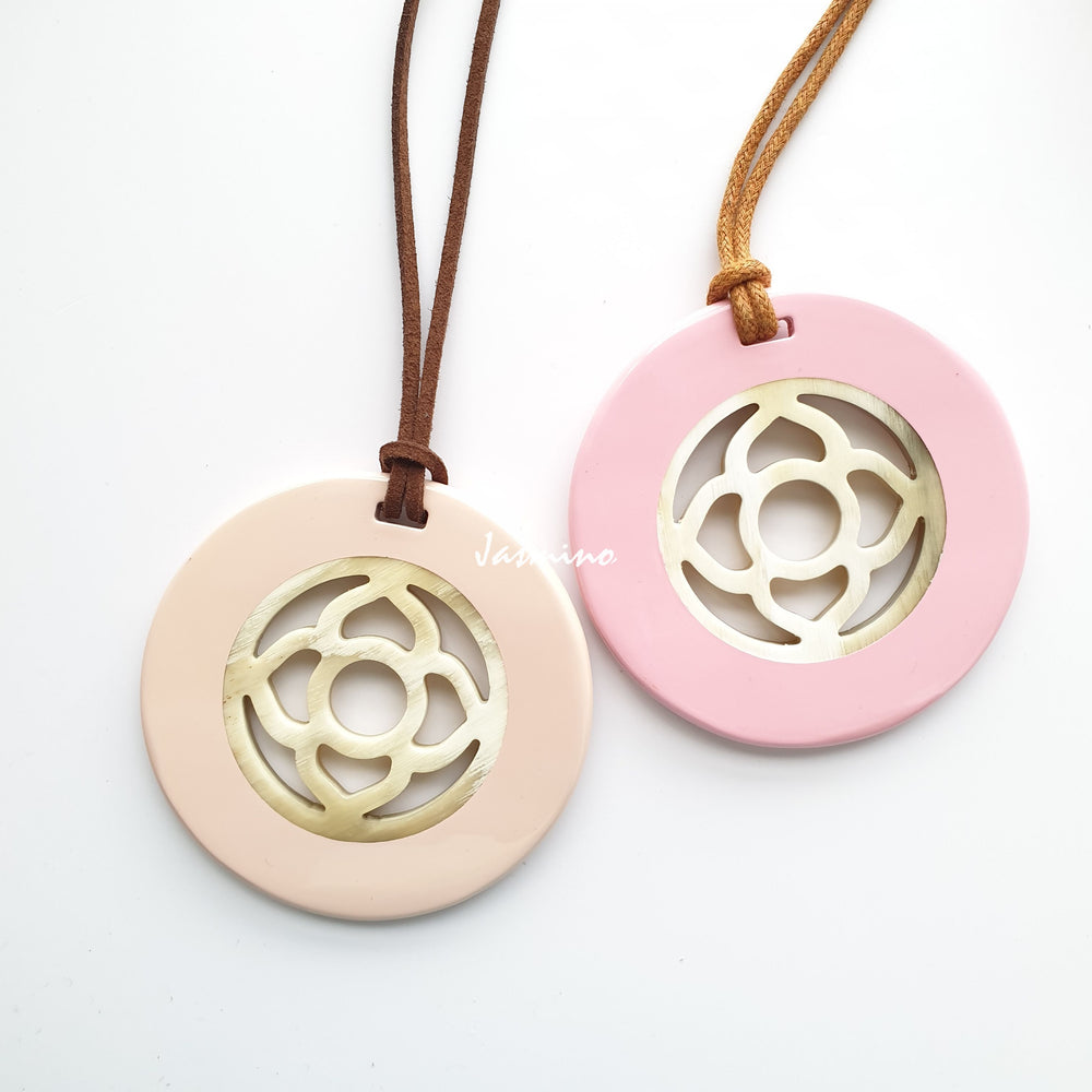 
                  
                    <img src = "buffalo horn pendant.jpg" alt = "round pendant with rose quartz outside, inside with flower pattern made from natural buffalo horn on a light background, an impressive gift for her">
                  
                