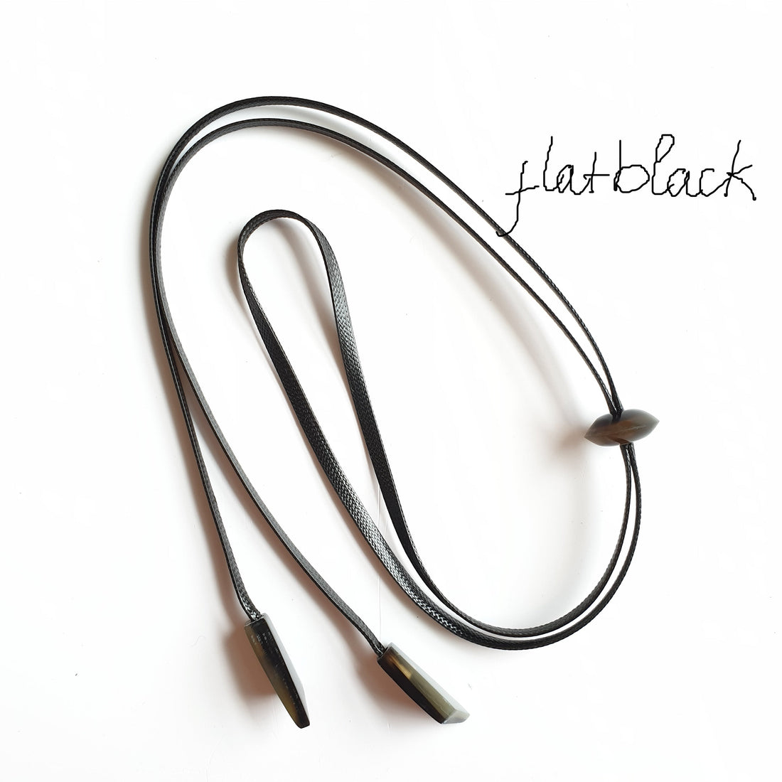  flat-black cord with small natural horn buffalo pieces on the light background, impressive gift for her