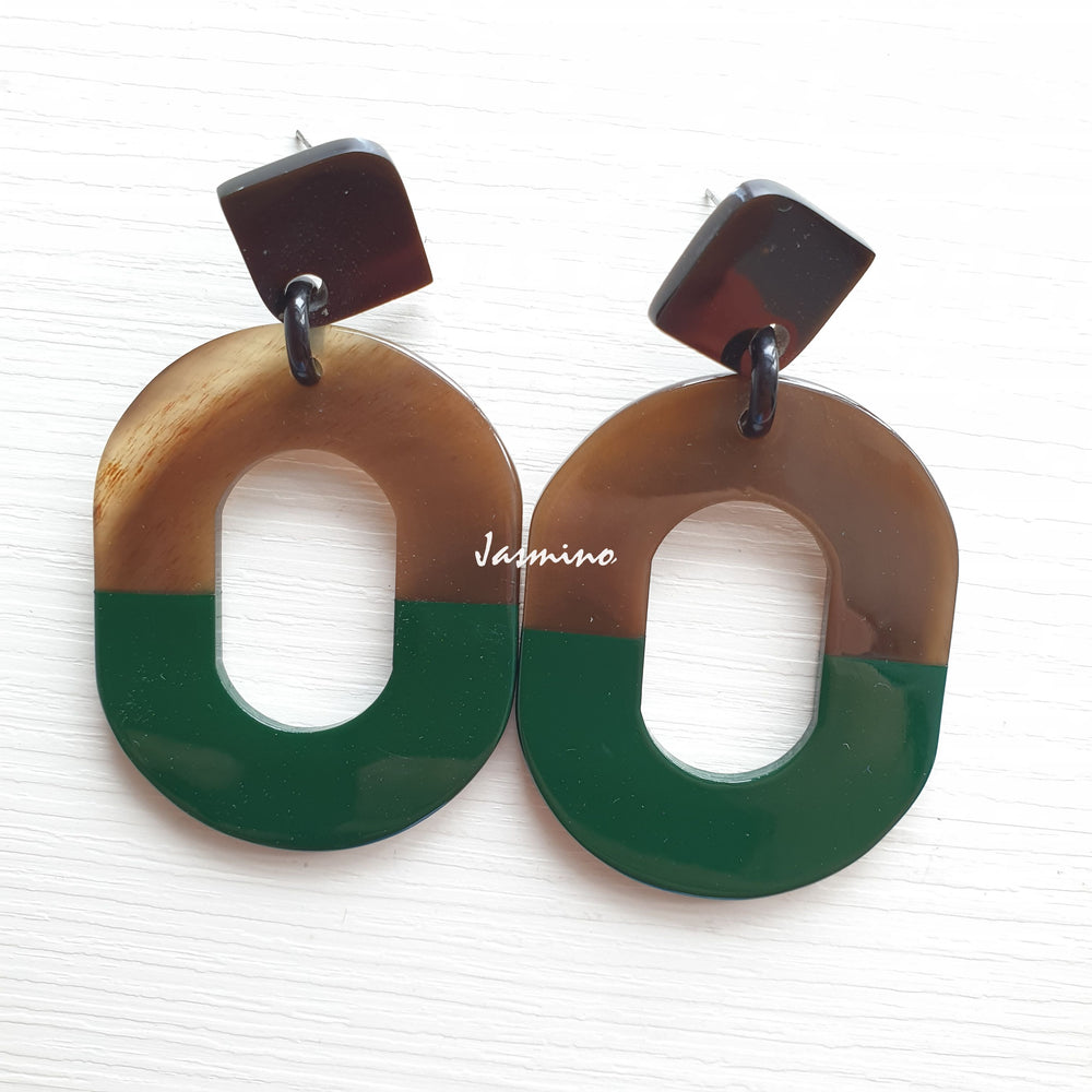 
                  
                    Handmade oval earrings feature dark green with natural buffalo horn material in the natural light as a unique Christmas gift
                  
                