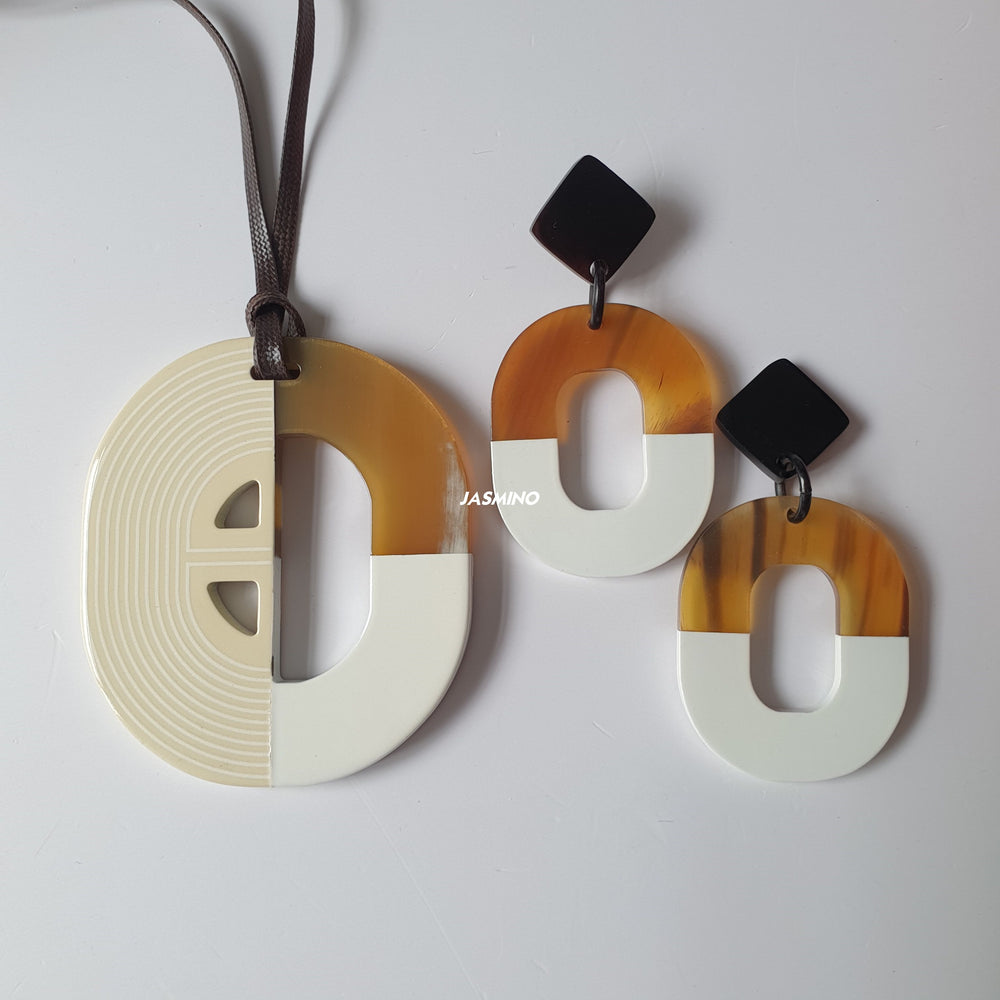 
                  
                    A collection of handmade oval earrings and a necklace is made by natural buffalo horn with light brown for casual events and night parties
                  
                