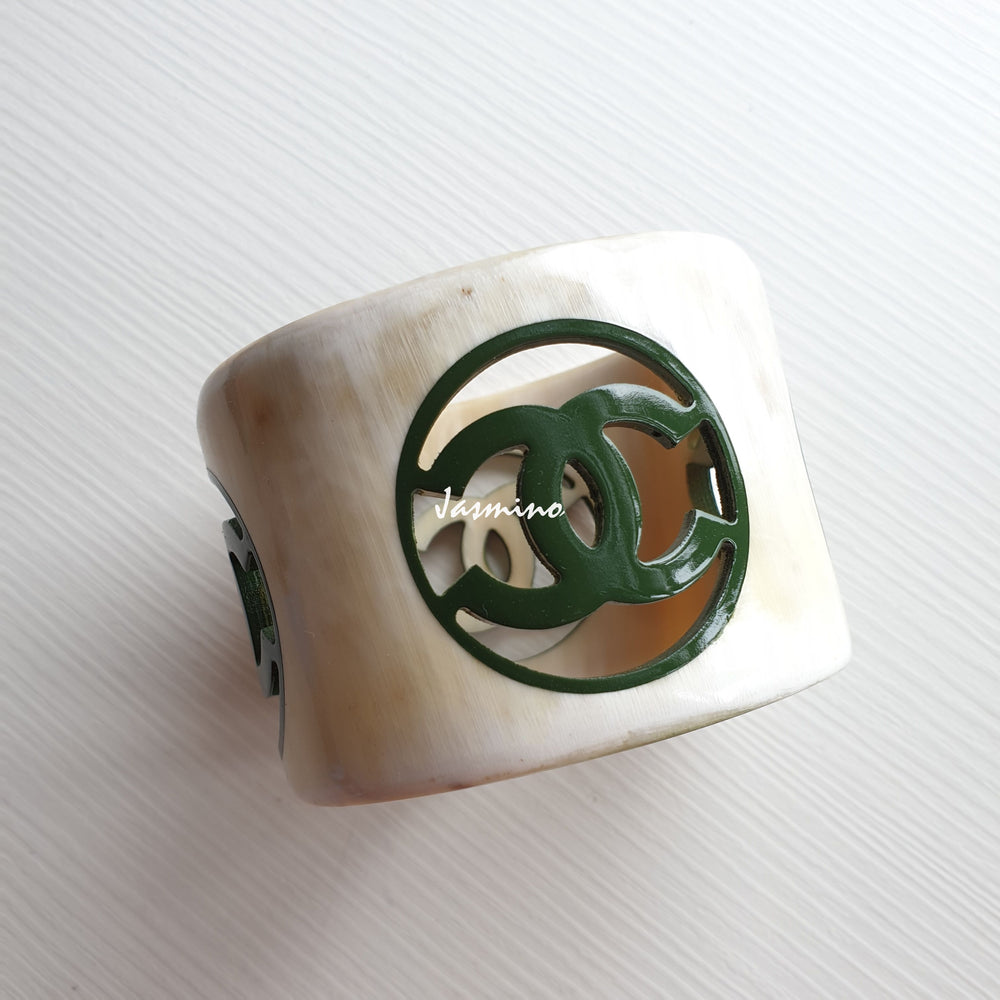 
                  
                    natural horn bracelet with chive Chanel symbol on a light background, a unique Christmas gift for her
                  
                