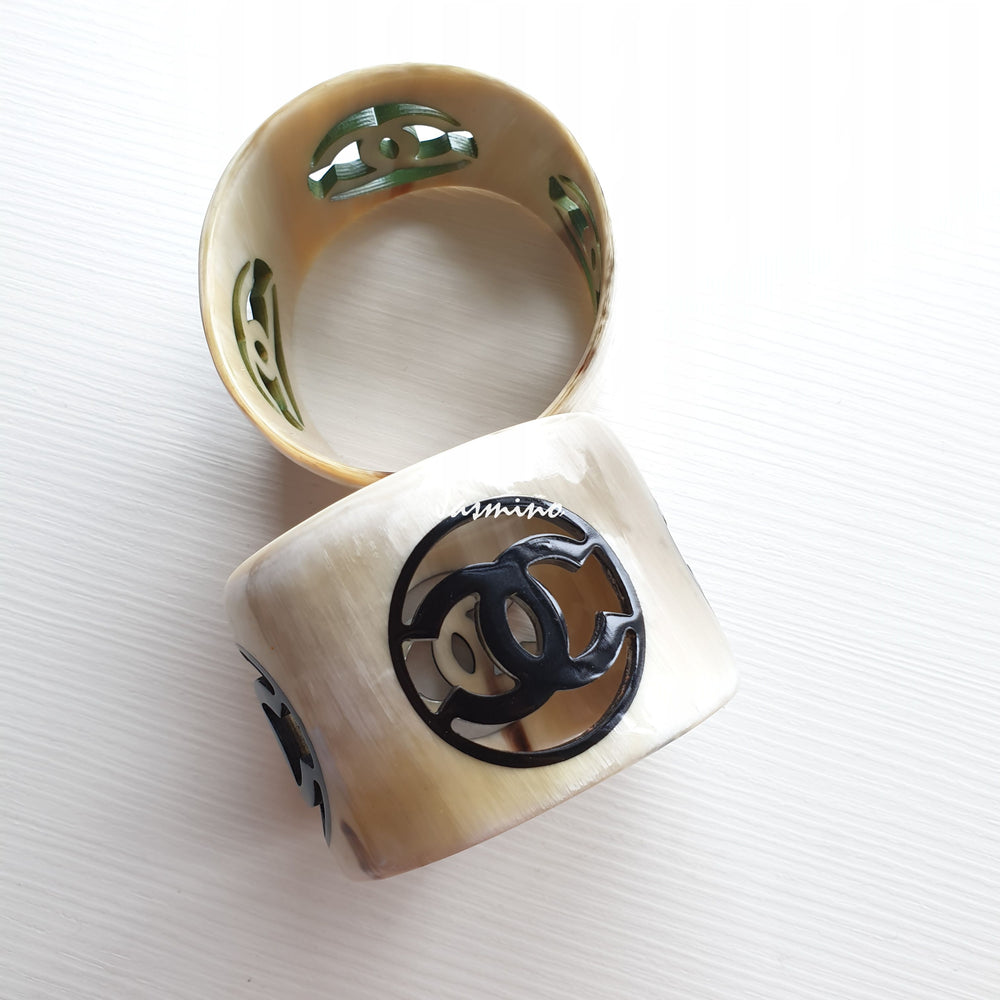 
                  
                    natural horn bracelet with black Chanel symbol on a light background, a unique gift for her
                  
                