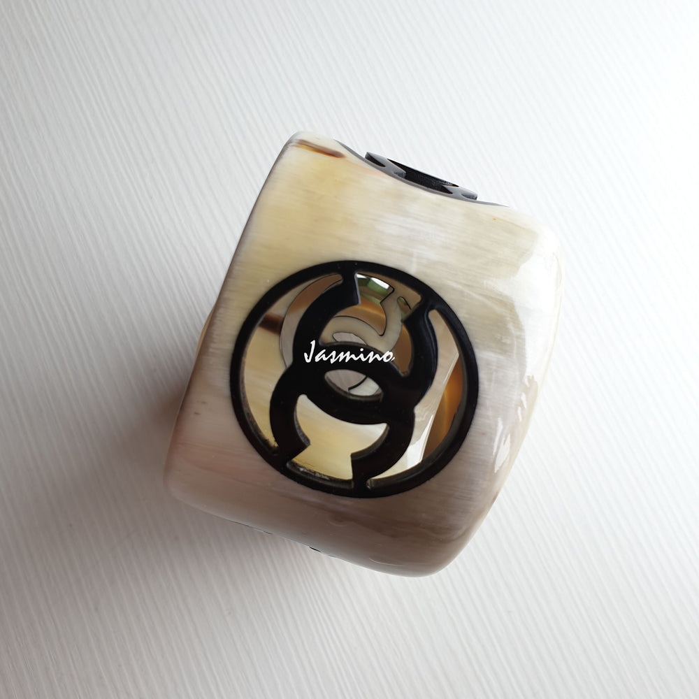 
                  
                    natural horn bracelet with black Chanel symbol on a light background, a unique gift for her
                  
                