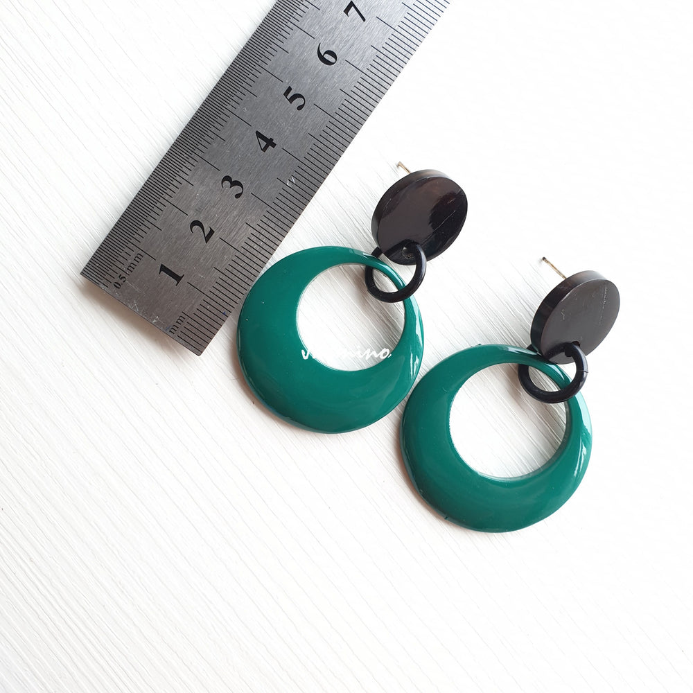
                  
                    Jasmino elegant crescent moon circular earrings feature pine green in the natural light
                  
                