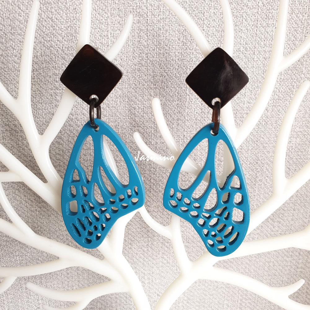 
                  
                    Butterfly-shaped blue lacquer buffalo horn earrings stand out on a bright background
                  
                