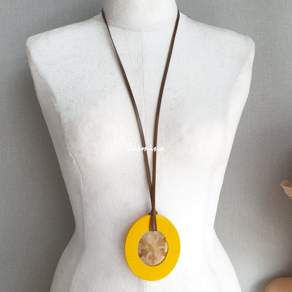 
                  
                    Elliptical yellow pendant with snowflake pattern inside on the light background, impressive gift for her
                  
                