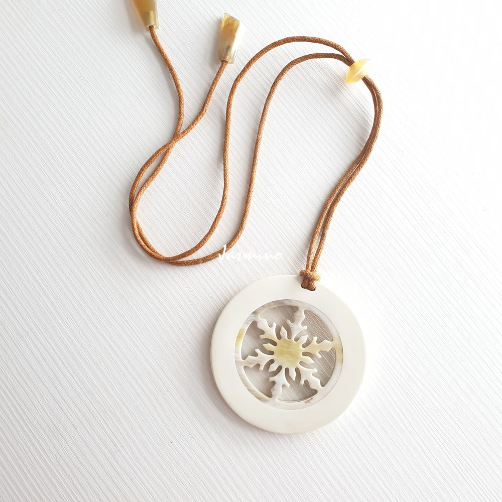 
                  
                    circular pendant is designed with brilliant white outline, inside with snowflake pattern made of unique natural buffalo horn on a light background, impressive Christmas gift for her 
                  
                