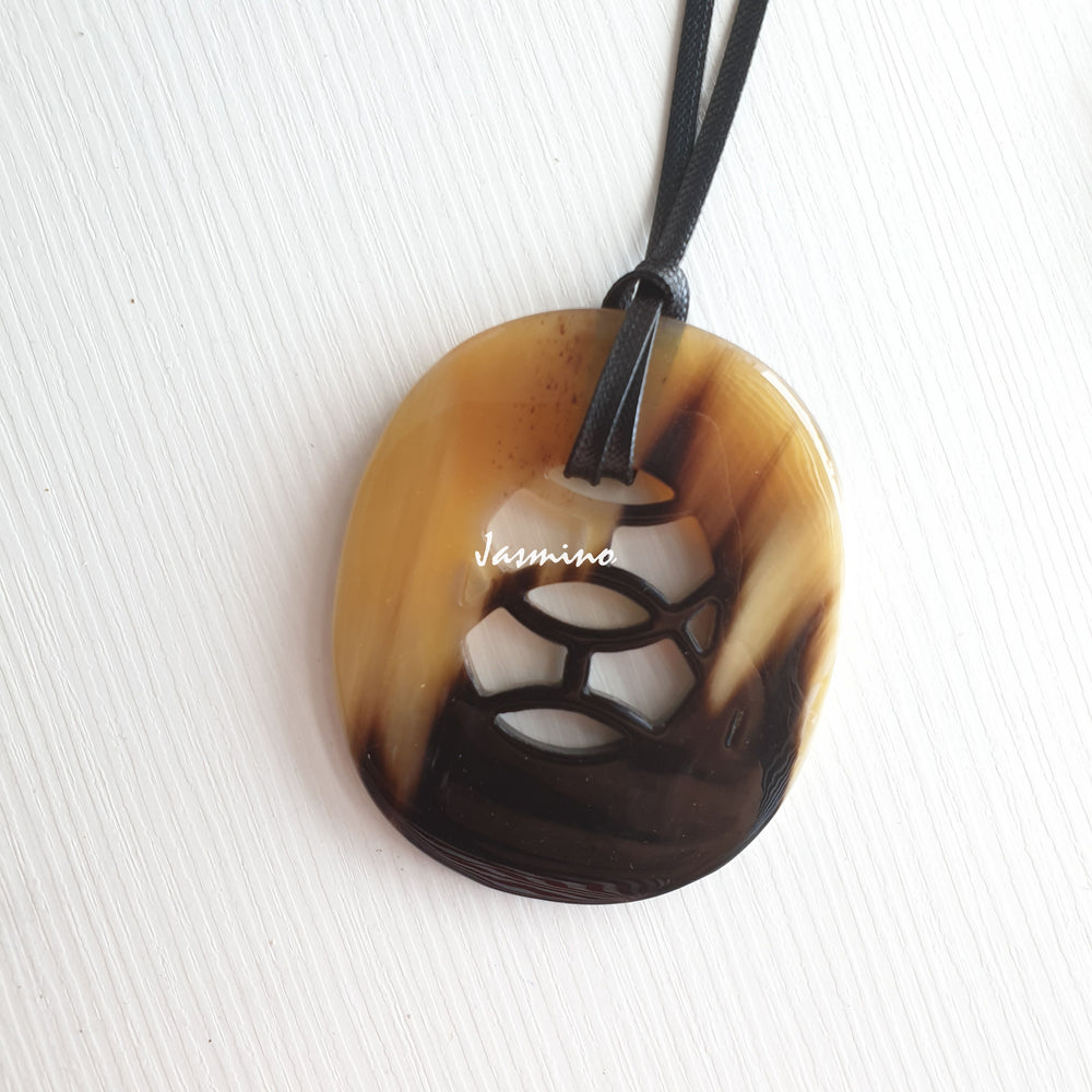 
                  
                    natural horn pendant with unique pattern on the light background, impressive gift for her
                  
                