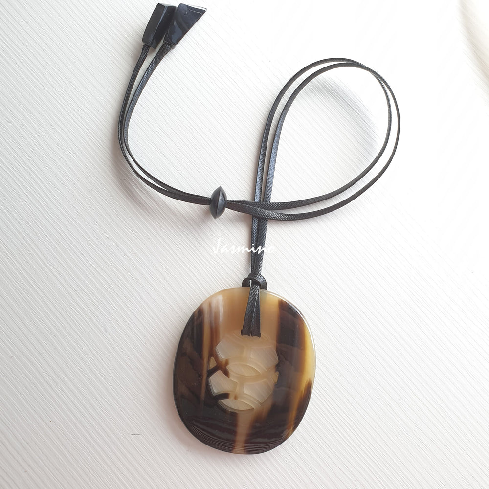 
                  
                    natural horn pendant with unique pattern on the light background, impressive gift for her
                  
                