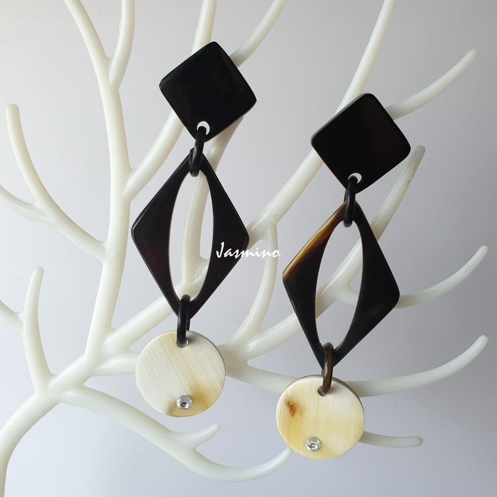 Handmade drop earrings feature black and white colors with Minimalist style on white faux branches