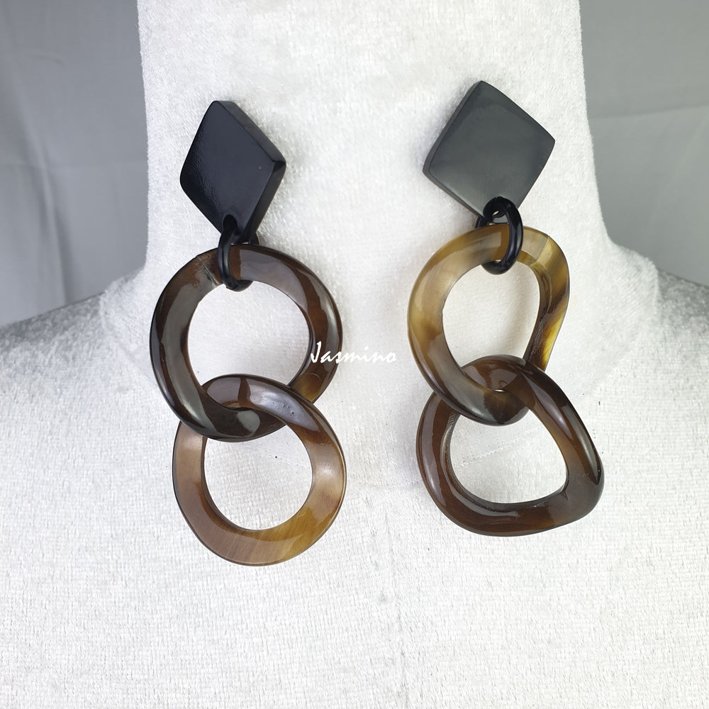 Handmade double circle hoop earrings feature a dark color with natural buffalo horn material on a mannequin