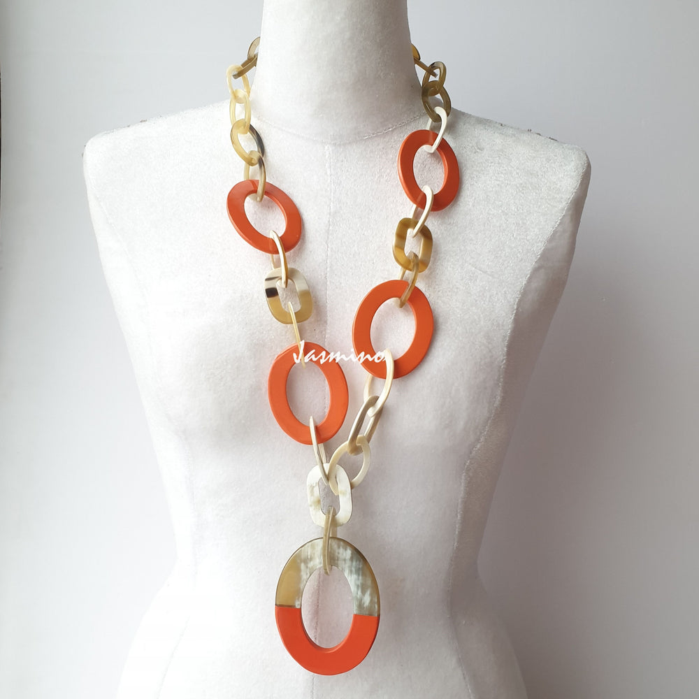 The necklace has several large orange peel pieces in natural light, impressive gift for her