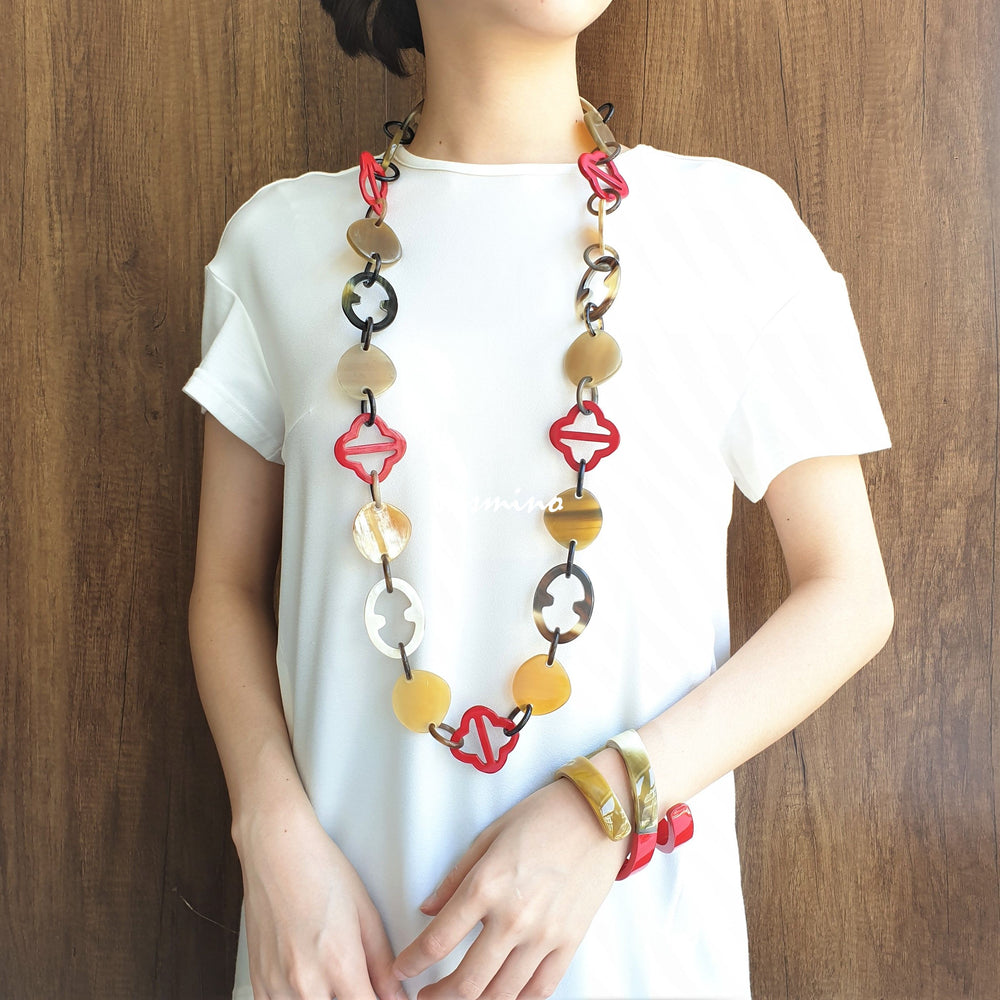 A model is wearing unique handmade Bohemian chain link necklace accessory featured red and white in natural buffalo horn for women