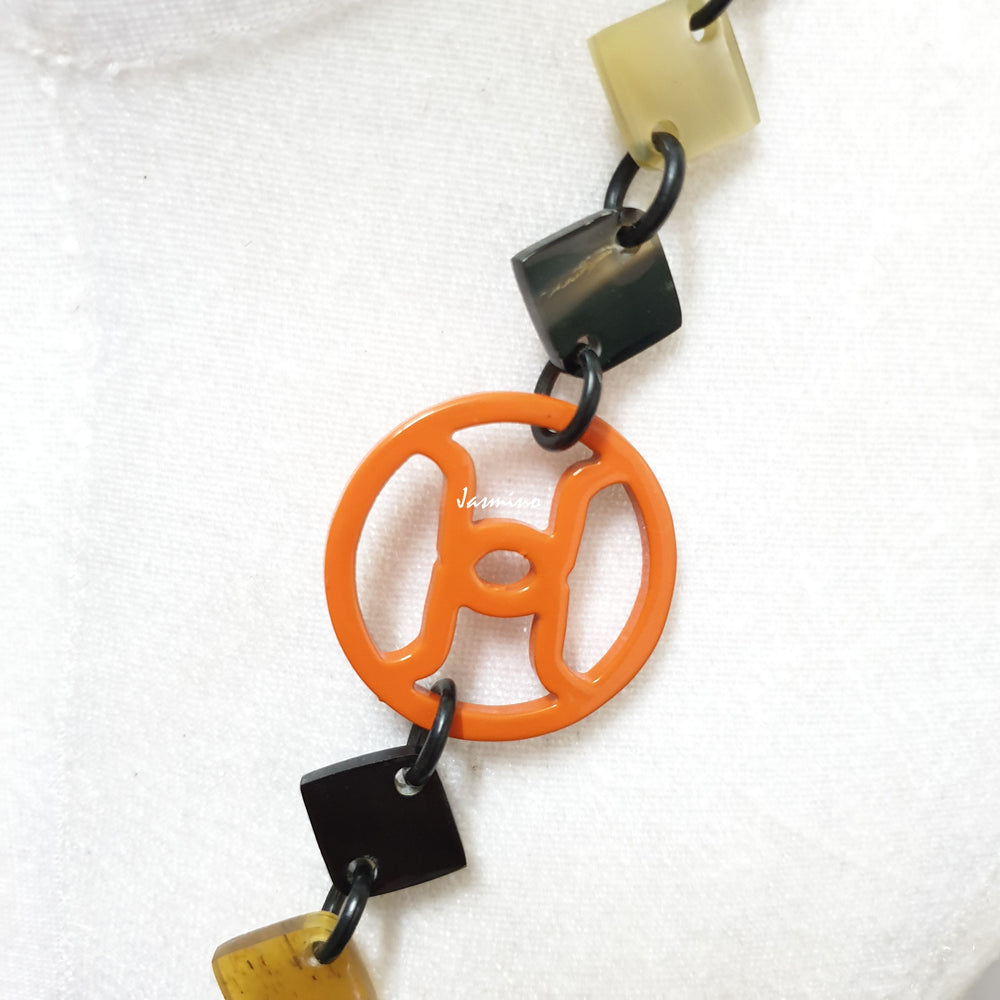 
                  
                    unique handmade Bohemian Ethnic diamond shaped chain link accessory is detailed by dark colours and bright circles in natural buffalo horn for festivals
                  
                