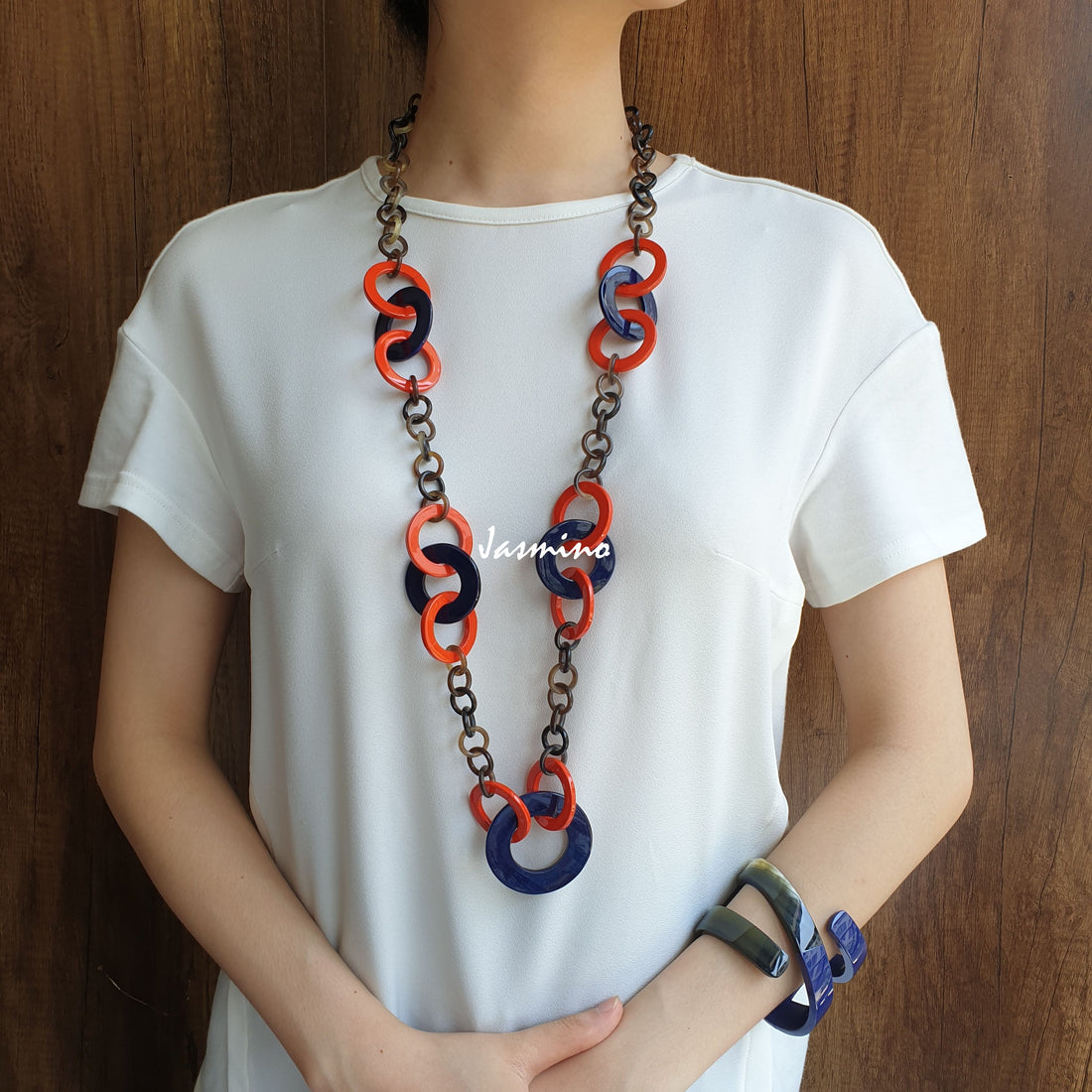 A set of Jasmino unique handmade Bohemian chain link necklace and bangle bracelet featured blue and orange in natural buffalo horn for women