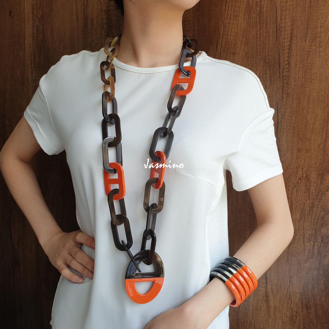 A model is wearing unique handmade Bohemian D-shaped chain link necklace featured brown and orange in natural buffalo horn for women's gifts