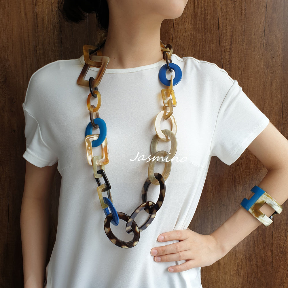 
                  
                    A model is wearing unique handmade circle rectangle necklace jewelry featured black and blue in natural buffalo horn 
                  
                