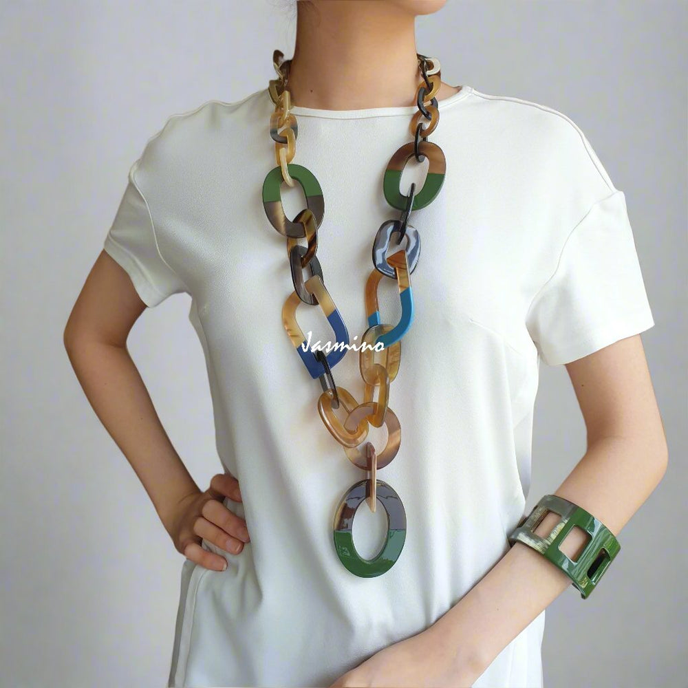
                  
                    A model is wearing Jasmino unique handmade Bohemian chain link necklace in natural buffalo horn with different colours for women on Christmas 
                  
                