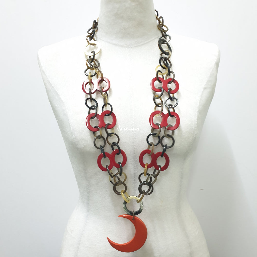 
                  
                     Jasmino unique handmade chain link necklace features an orange crescent moon pendant jewelry accessory in natural buffalo horn for women
                  
                