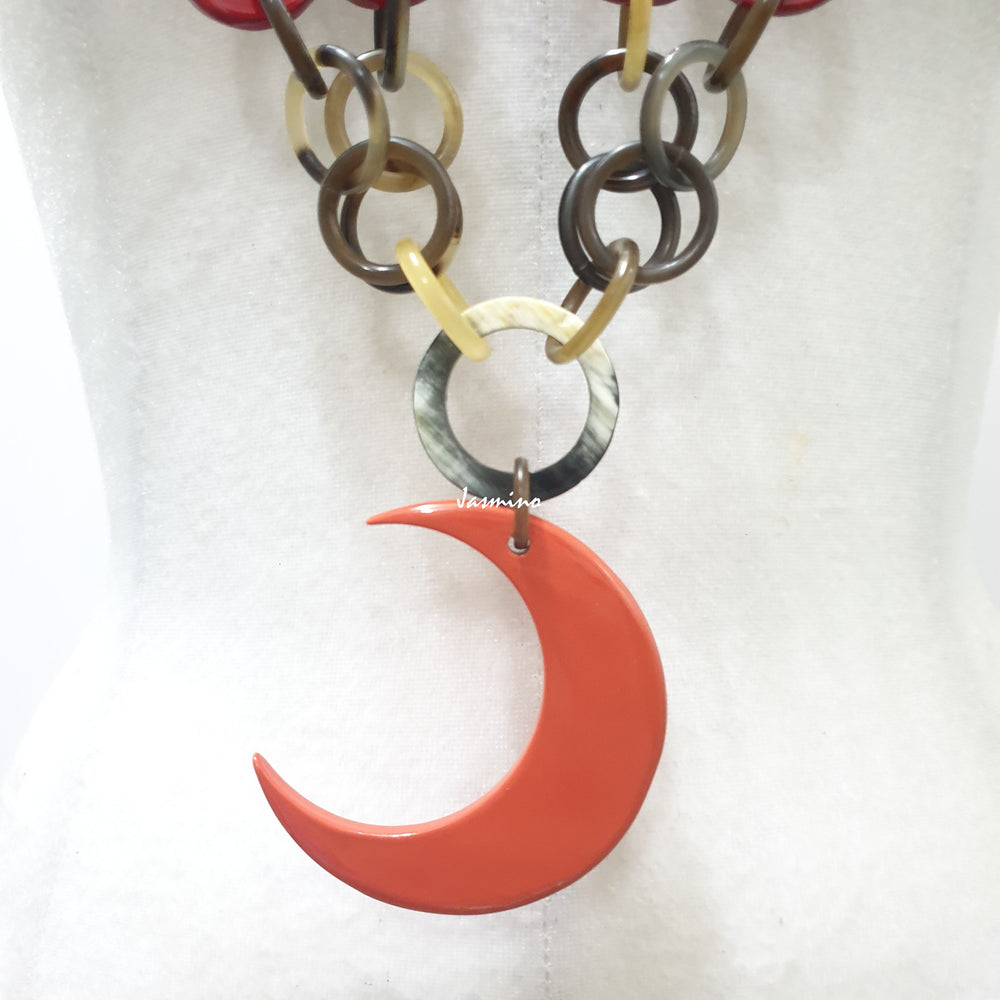 
                  
                     Jasmino unique handmade chain link necklace features an orange crescent moon pendant jewelry accessory in natural buffalo horn for women
                  
                