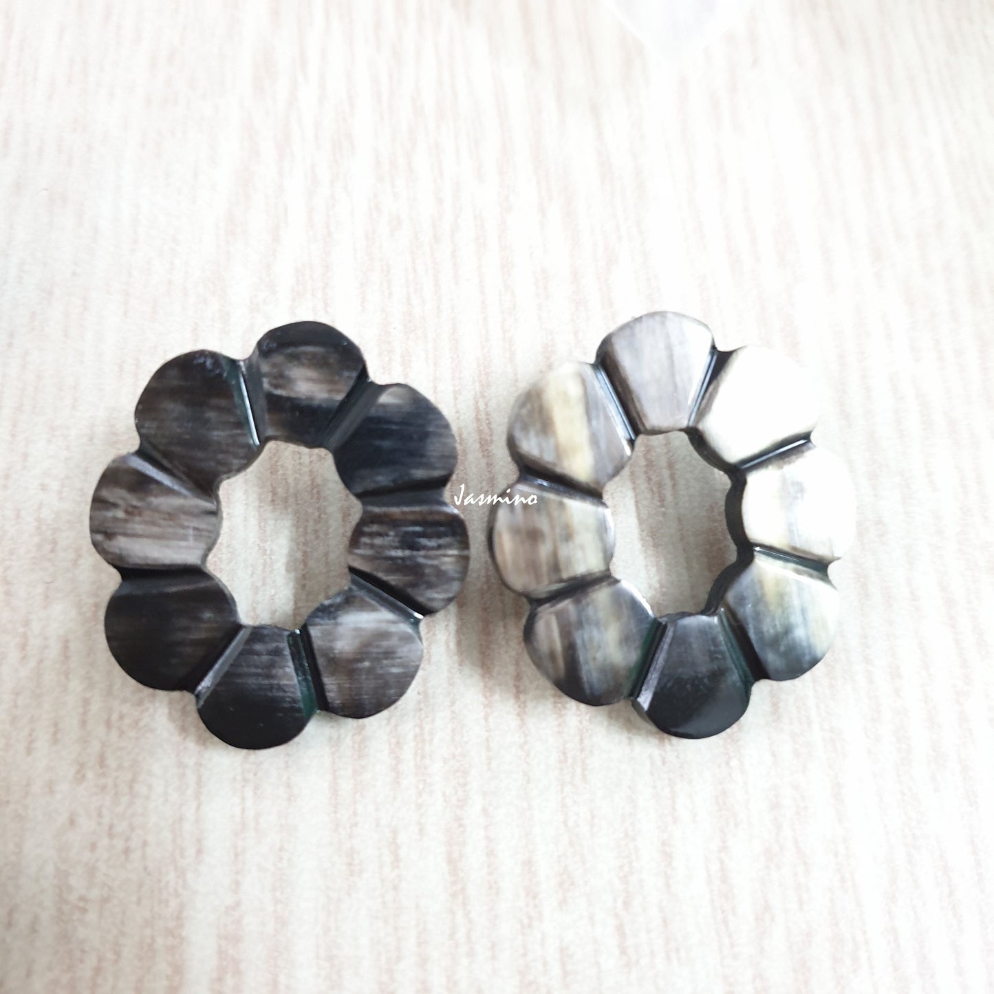 <img src = "buffalo horns.jpg" alt = "dark natural horn flower-shaped earrings on a light background, an impressive gift for her">