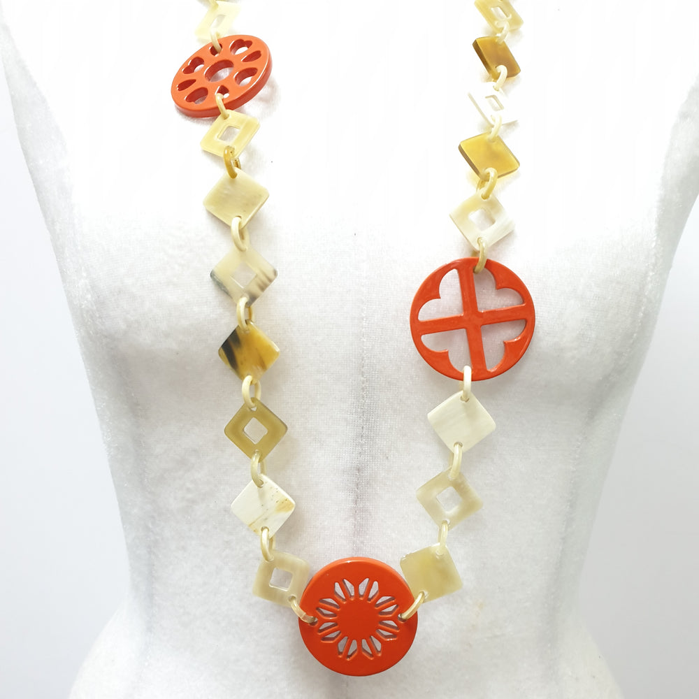 
                  
                    This necklace has some large orange pieces with different patterns on the light background, unique gift for your friend
                  
                