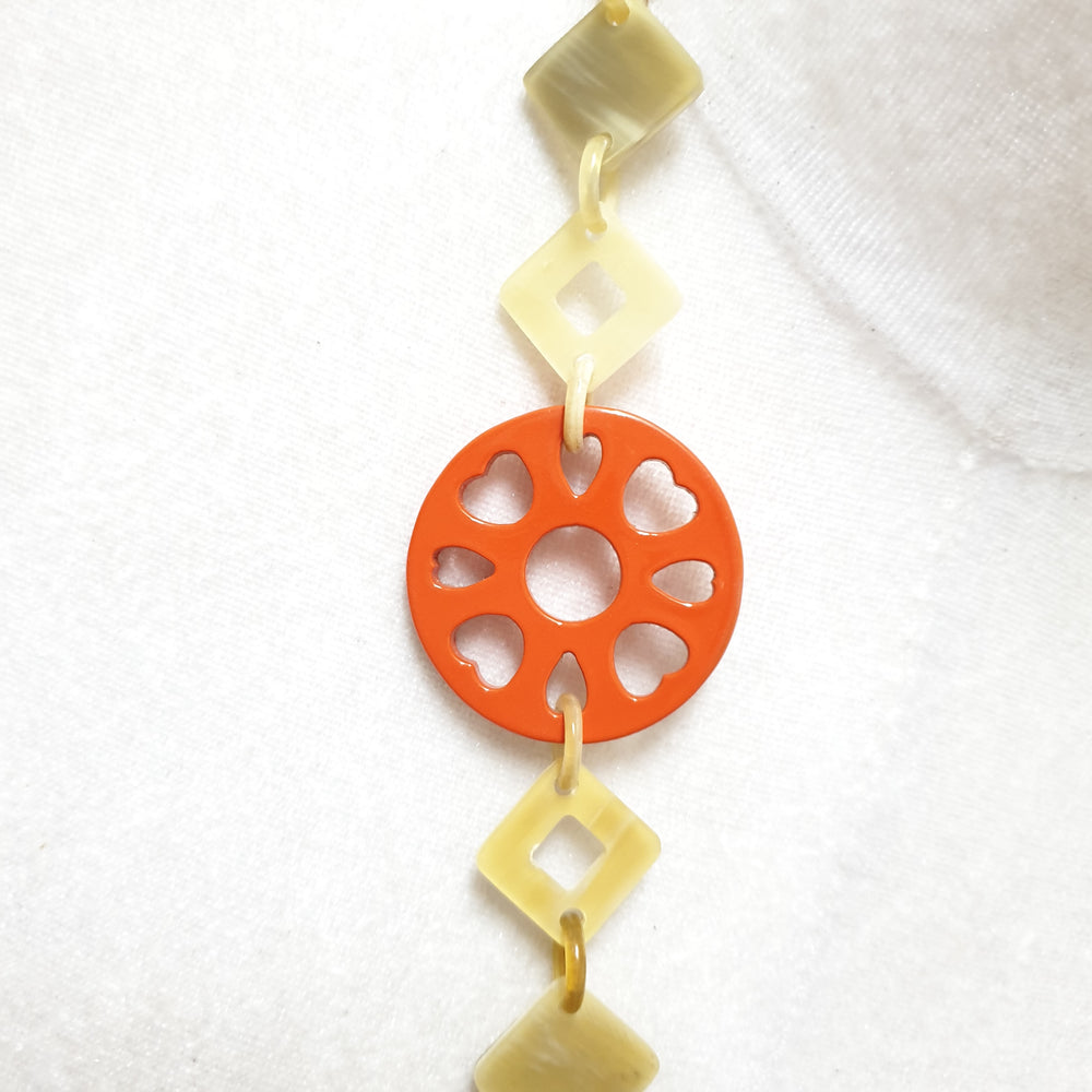 
                  
                    This necklace has some large orange pieces with different patterns on the light background, unique gift for your friend
                  
                