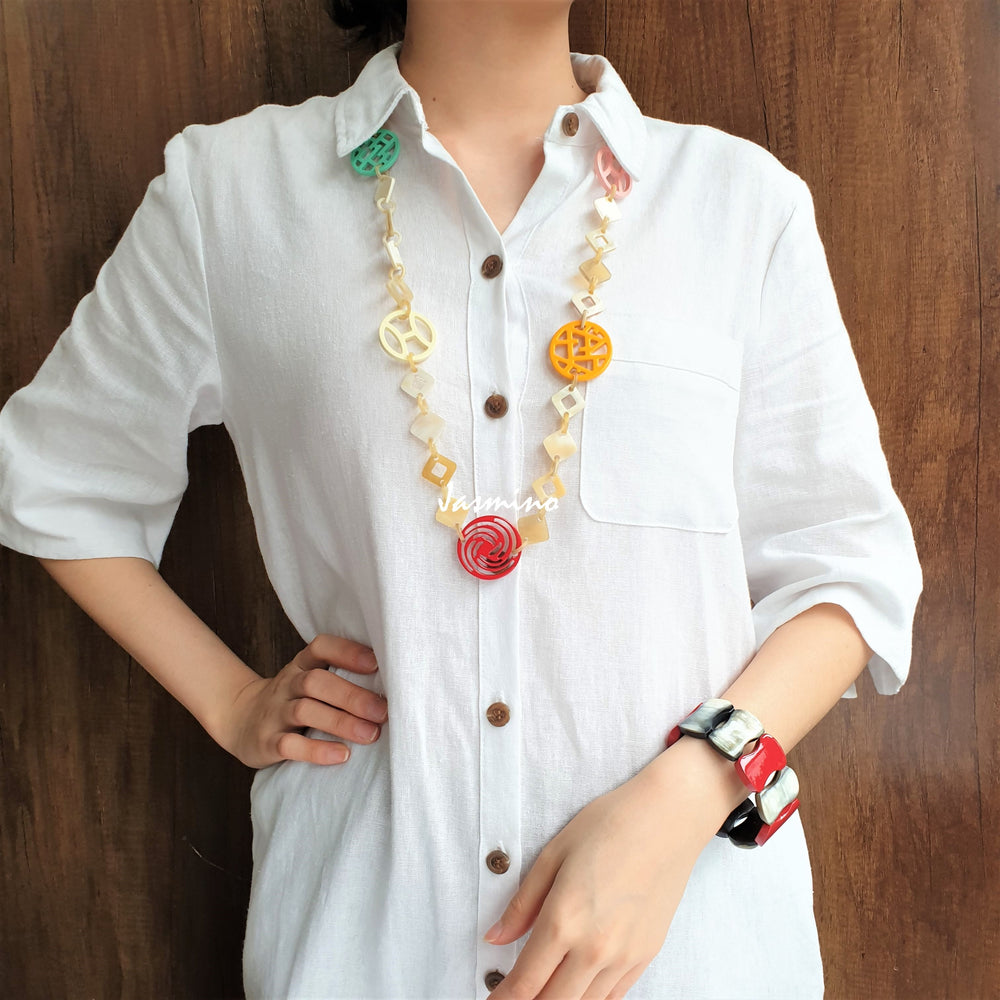 
                  
                    A model is wearing unique handmade necklace featured several pieces with different patterns and colors on the light background, unique gift for your friend
                  
                