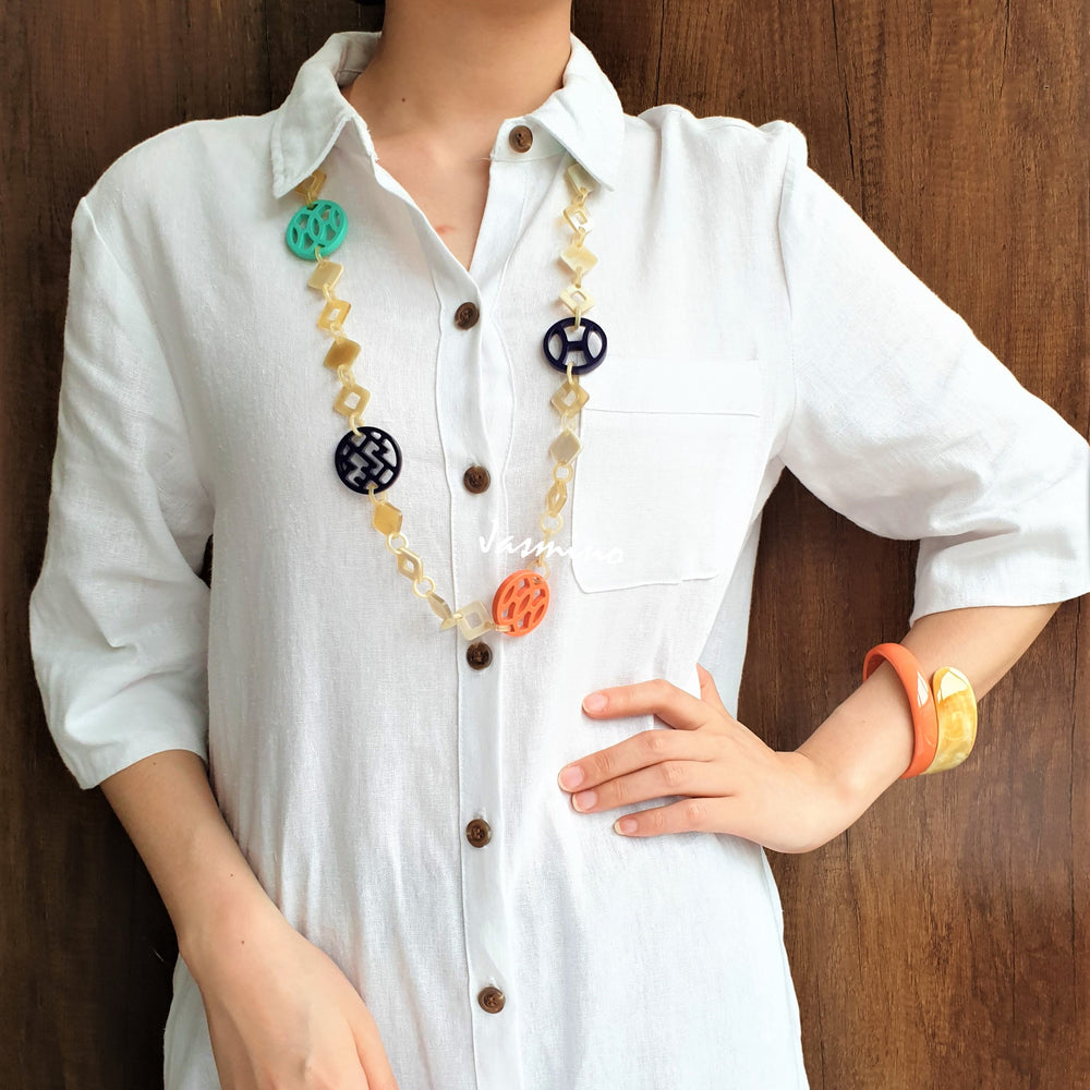 
                  
                    A model is wearing unique handmade necklace featured several pieces with different patterns and colors on the light background, unique gift for your friend
                  
                