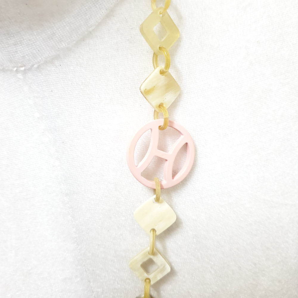 
                  
                    This necklace have several pieces with different patterns and colors on the light background, unique gift for your friend
                  
                