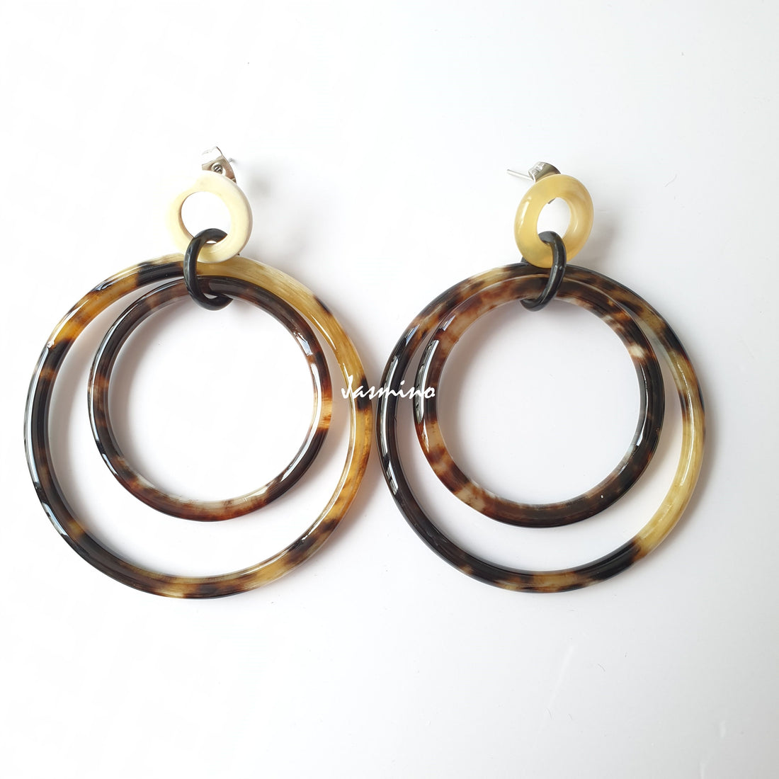 Handmade double circle drop earrings feature the color of leopard skin and natural buffalo horn in the natural light