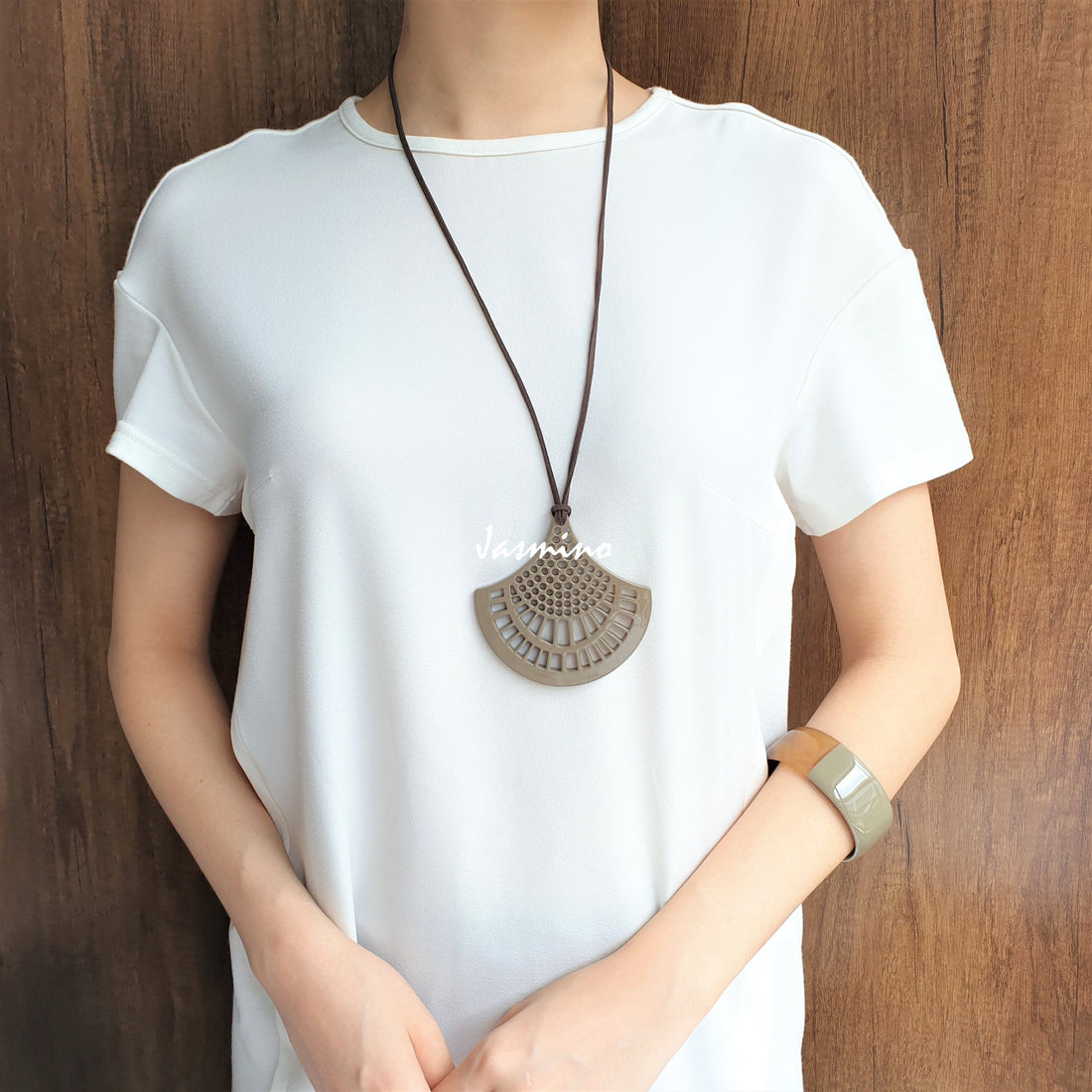 A women is wearing Vintage unique handmade pendant features a beige colour made of natural buffalo horn for women
