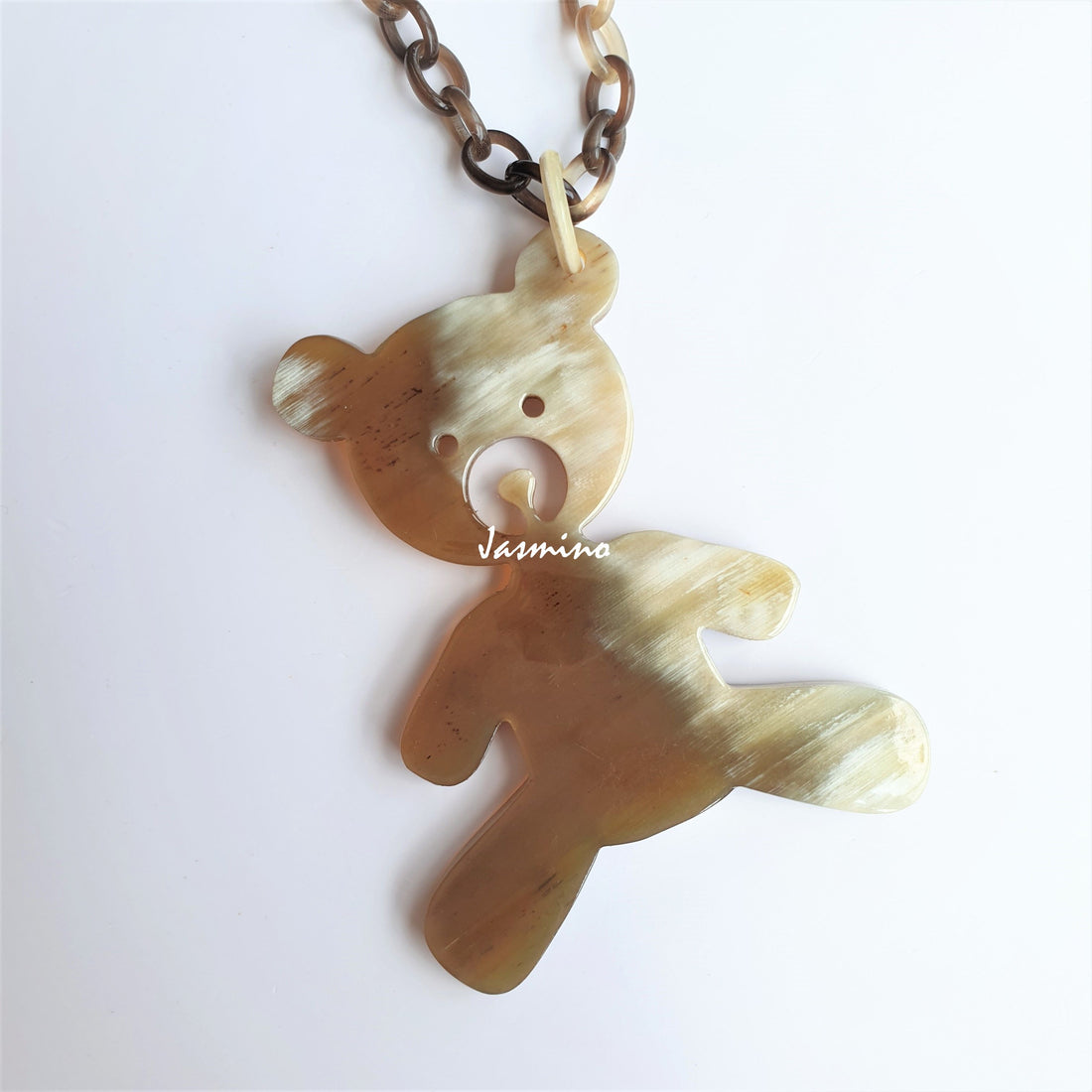 Unique handmade pendant is shaped by a bear that is made of natural buffalo horn for girls