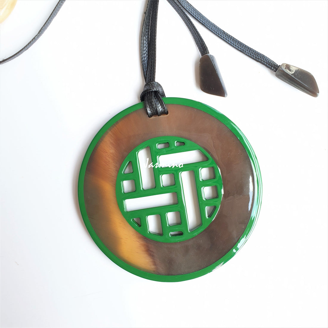 Vintage unique pendant features brown and green made of natural buffalo horn