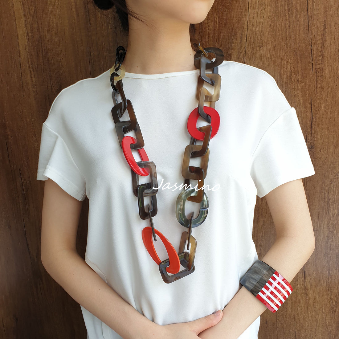 A model is wearing Jasmino unique handmade Vintage rectangle chain necklace featured brown and red in natural buffalo horn for women