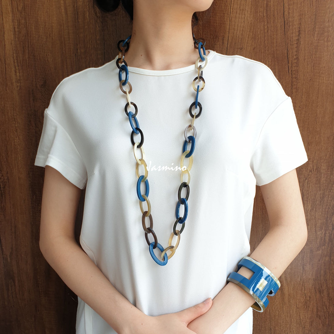 A model is wearing Jasmino unique handmade Vintage small chain necklace features blue and brown in natural buffalo horn for women